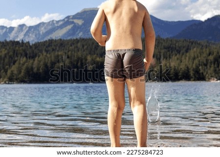 Similar – sports guy in his underwear looking at the river