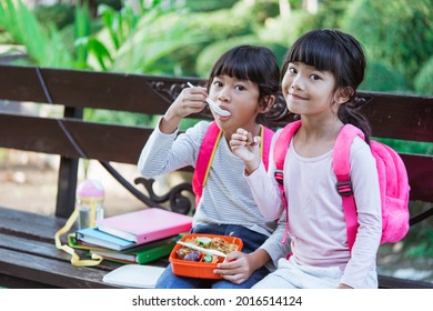 Kid Primary School Student Enjoying Eating Their Meal In Lunch Box