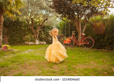 Kid In A Princess Costume Dancing Go Round And Round. Outdoors