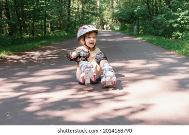 Kid In Protective Sportswear. Cute Kid Girl Learning To Roller Skate