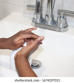 Kid Pumping Soap To Wash Hands In Sink