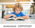 Kid reading book. Child reading book in a public library. School kid reading book in school library. Smart girl selecting literature for reading. Books on shelves in bookstore. Learning from books.