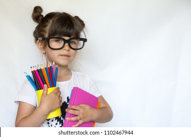 Kid Ready For School. Cute Clever Child In Eyeglasses Holding School Supplies: Pens, Notebooks, Scissors And Apple. Back To School Concept. Space For Text, Isolated On White.