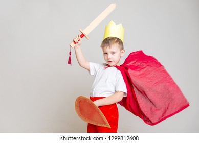 The Kid In The Red Knight's Costume With A Crown