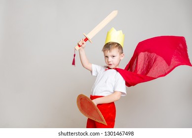 The Kid In The Red Knight's Costume With A Crown