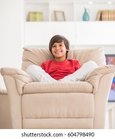 Kid relaxed on sofa - Shutterstock ID 604798490
