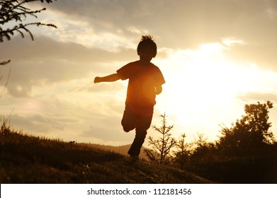 Kid Running On Meadow Silhouette