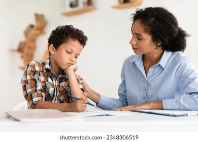 Kid School Learning Problems. Mom Comforting And Supporting Unhappy Schoolboy Son While He Having Hard Time With Homework Sitting At Desk Indoors. Child Suffering Having Educational Issue - Powered by Shutterstock