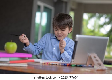 Kid self isolation using tablet for his homework,Child doing using digital tablet searching information on internet during covid 19 lock down,Home schooling,Social Distance,E-learning online education