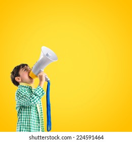 Kid Shouting By Megaphone Over Yellow Background