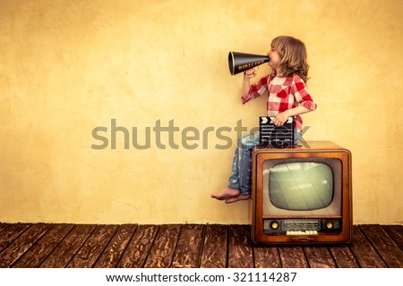 Kid shouting through vintage megaphone. Communication concept. Retro TV