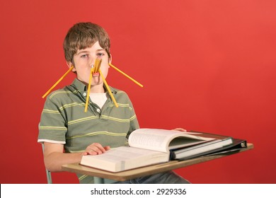 Kid Showing Off Being Silly With Pencils