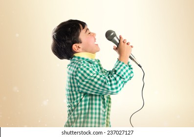 Kid Singing Over Ocher Background 