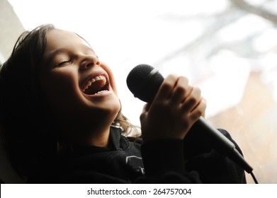 Kid singing song with microphone