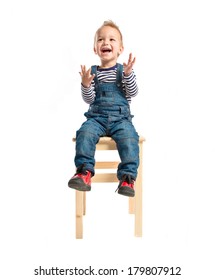 Kid Sitting And Clapping Over White Background