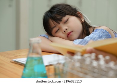 Kid sleeping while doing science experiments. Education science concept - Powered by Shutterstock