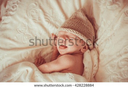 Similar – Newborn baby girl sleeping lying on bed next to mother’s hand