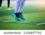 Kid soccer player Jogging and jump between marker for football training.