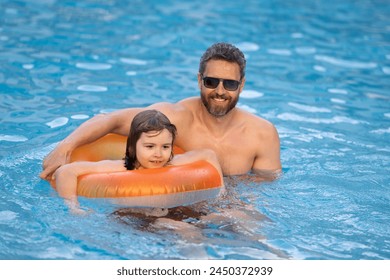 Kid splash water in pool. Father and son swimming and splashing in blue sea water. Family on summer holiday. Happy parents and children relaxing on beach. Dad and child playing in poolside. - Powered by Shutterstock