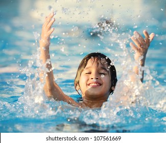 Kid Splashing On Summer Pool