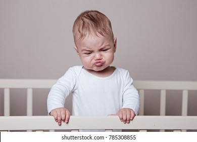 
the kid is standing in a baby crib folded sponge, funny emotion, white background