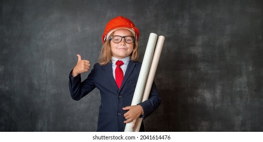 Kid In Suit With Construction Tools. Little Girl In Businessman Suit And Glasses. Little Girl In Red Safety Helmet. Child Protection. Baby Building. Making Repairs. Portrait Of A Child Builder.