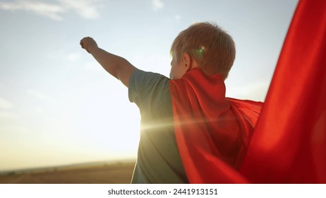 kid superhero. boy happy family dream concept. baby boy superhero close-up in red cape at sunset. portrait child superhero close-up from the back. strength lifestyle fantasy concept - Powered by Shutterstock