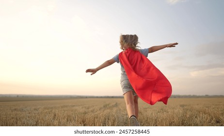 kid superhero run. girl daughter happy family dream concept. baby girl superhero run in red cape at sunset. portrait child superhero in the park. strength fantasy lifestyle concept - Powered by Shutterstock