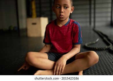 Kid With Surprised Face Did Something Bad, Oops Facial Expression. Latino American Child Looking Away And Point On Floor, Afraid Of Punishment. Got In Trouble, Emotion, Scared, Sorry, Oops Concept