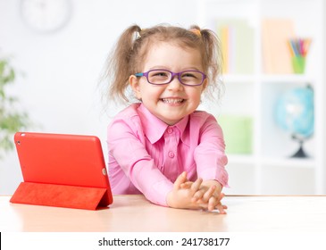 Kid With Tablet In Glasses As Early Education Concept