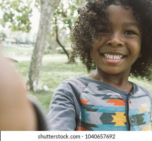 Kid Taking Selfie In Park