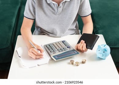 Kid teen boy counting money and taking notes, saving money in a piggy bank. Learning financial responsibility and projecting savings. Concept of finance, business, investment. Lessons in mindfulness - Powered by Shutterstock