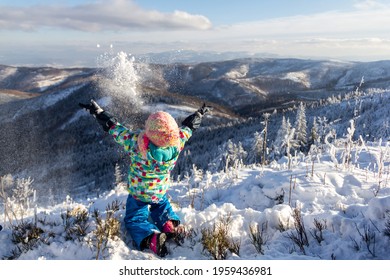 Kid Throwing Snow Up In The Air In Polish Mountains During Sunny Winter Day In Malinowska Skala, Szczyrk