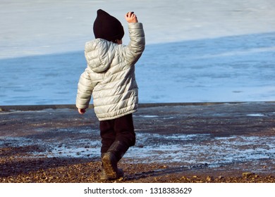 Kid Throwing Stone In Water. Child In Action Of Throwing Stone Or Rock In Water