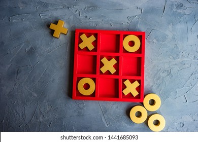 Kid tic-tac-toe board game concept on concrete background with copy space - Shutterstock ID 1441685093