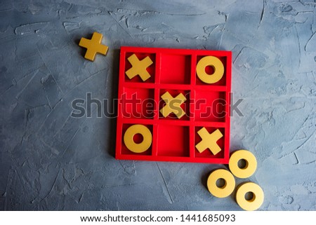 Kid tic-tac-toe board game concept on concrete background with copy space