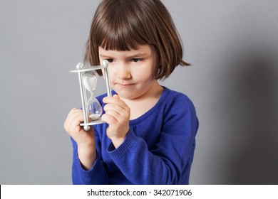 Kid Time Concept - Concentrated Preschool Child Enjoying Learning About Time, Holding An Egg Timer For Innocence And Future,studio Shot