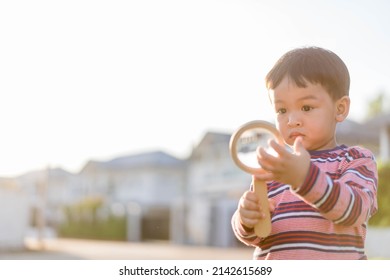 Kid Toddler 2 Years Old Boy Child Holding Magnifying Glass And Check DNA Test Concept On His Hand For .Hand Washing And Germs On Hands.Genetic Testing.Potential.Health Cancer On Skin.Education.observe