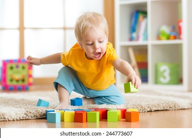 Kid Toddler Playing  Wooden Toys At Home Or Nursery