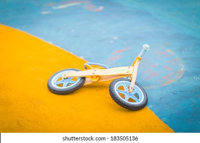 Kid Toy Bike Abandoned And On The Asphalt Ground