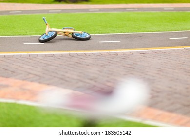 Kid Toy Bike Abandoned And On The Asphalt Ground