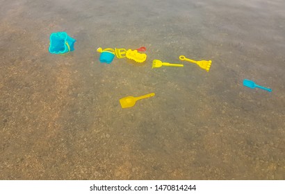 Kid Toys Floating In The Sea. Concept Of Someone Drowning.