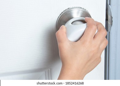 A Kid Trying To Open The Door With A Child Proof Door Knob Covers Over Doorknob.