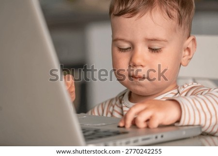 Kid using computer at home, concept of screen dependency and behavior patterns.