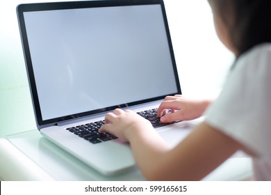 Kid Using Laptop With White Copy Space Screen .