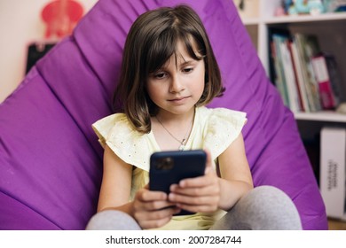 Kid Using Smartphone, Child Browsing Internet On Smart Phone, Teenager Girl Communicating With Parents, Technology On Device. Girl Using Mobile Phone Or Chat