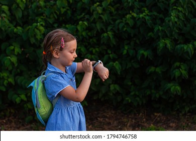 Kid using smartwatch outdoor in park. Child talking on vdeo call on the smartphone. Schoolgirl using touchscreen display on watches browsing internet. Smart wristwatch with GPS tracker. - Powered by Shutterstock