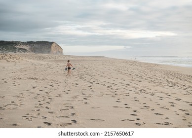 A Kid Walking Along The Sandy Beach In Denmark, Romo