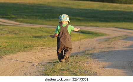 Kid Walking Away On A Country Road