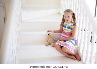 Kid Walking Stairs In White House. Little Girl Playing In Sunny Staircase. Family Moving Into New Home. Child Climbing Steps Of Modern Stairway. Foyer Or Living Room Interior. Home Safety For Toddler.
